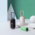 Load image into Gallery viewer, Two portable trash cans, one blue and one white with a pink handle, on a light surface with a green wall background.