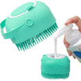 Load image into Gallery viewer, Green scrubber with bristles being filled with a white liquid from a bottle on a white background
