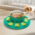 Load image into Gallery viewer, Dog interacting with a green and teal puzzle toy on a light-colored floor.

