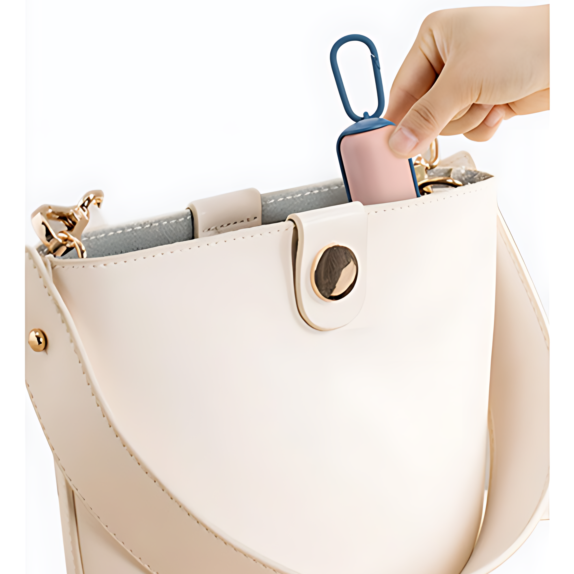 Hand placing a pink phone case into a beige handbag.